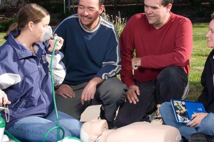 a group of people sitting at a park